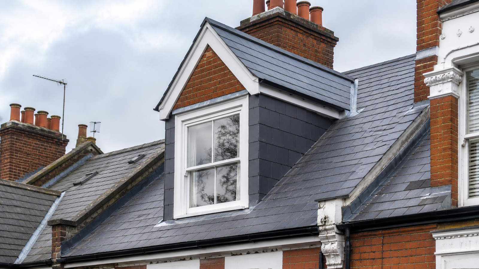 A newly constructed pitched dormer window with slate cheeks and lead flashing on a Victorian property in Belsize Park NW3 built by expert roofing Belsize Park contractors.